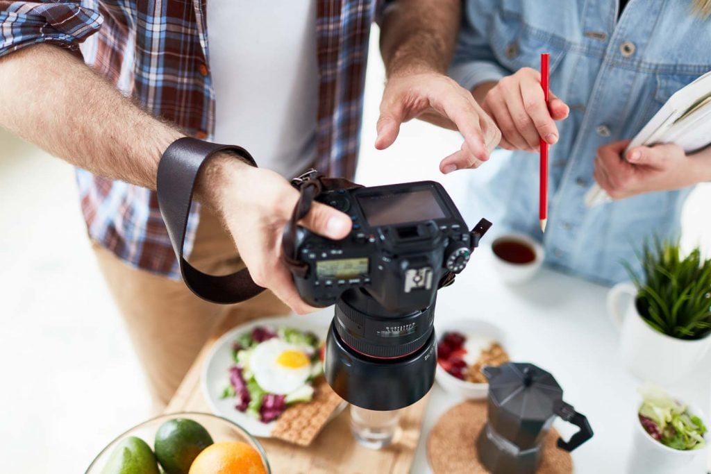 Professional food videographers manipulating a camera